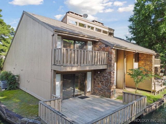 6002 S Atlanta Ct Unit 2, Tulsa, OK 74105 - back of house featuring stone siding, a balcony, a deck, and roof with shingles