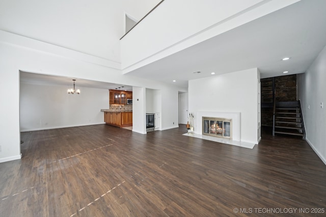 6002 S Atlanta Ct Unit 2, Tulsa, OK 74105 - unfurnished living room with a fireplace with flush hearth, a chandelier, dark wood-style floors, recessed lighting, and stairway