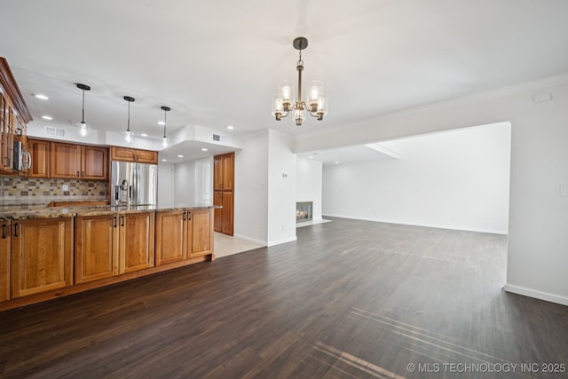 6002 S Atlanta Ct Unit 2, Tulsa, OK 74105 - kitchen featuring stainless steel fridge, recessed lighting, wood finished floors, light stone counters, and brown cabinetry