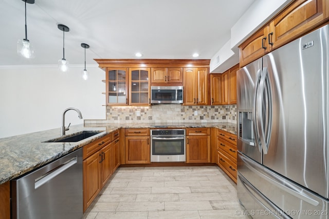 6002 S Atlanta Ct Unit 2, Tulsa, OK 74105 - kitchen featuring stainless steel appliances, brown cabinetry, stone counters, glass insert cabinets, and pendant lighting