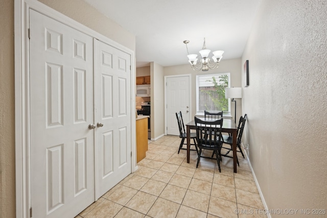 6152 S Madison Pl Unit B, Tulsa, OK 74136 - dining space featuring light tile patterned flooring, a chandelier, and a textured wall