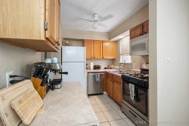 6152 S Madison Pl Unit B, Tulsa, OK 74136 - kitchen with stainless steel appliances, ceiling fan, light tile patterned flooring, light countertops, and a textured wall