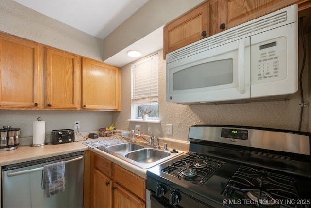 6152 S Madison Pl Unit B, Tulsa, OK 74136 - kitchen featuring appliances with stainless steel finishes, light countertops, and a textured wall