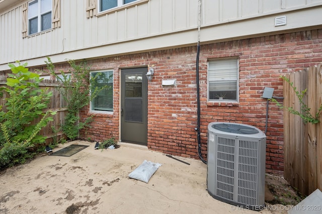 6152 S Madison Pl Unit B, Tulsa, OK 74136 - property entrance featuring board and batten siding, a patio, and brick siding
