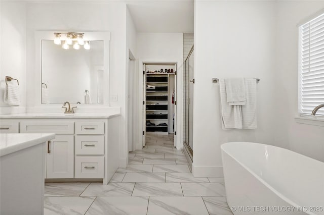 2035 E 138th Pl S, Bixby, OK 74008 - bathroom with a spacious closet, a shower stall, vanity, and a freestanding tub