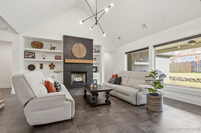 2035 E 138th Pl S, Bixby, OK 74008 - living area with built in shelves, a chandelier, high vaulted ceiling, and a brick fireplace