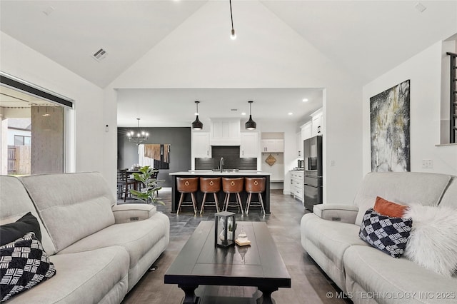 2035 E 138th Pl S, Bixby, OK 74008 - living room with vaulted ceiling, recessed lighting, and a chandelier