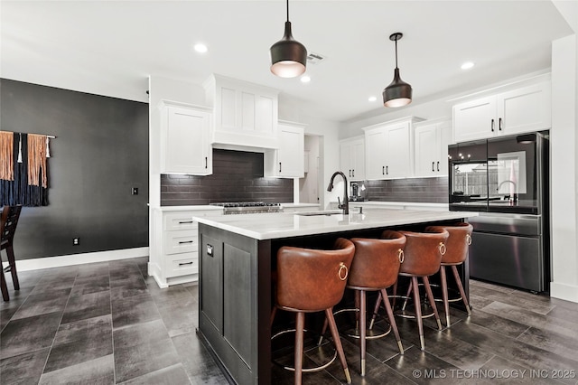 2035 E 138th Pl S, Bixby, OK 74008 - kitchen with smart refrigerator, light countertops, tasteful backsplash, an island with sink, and recessed lighting