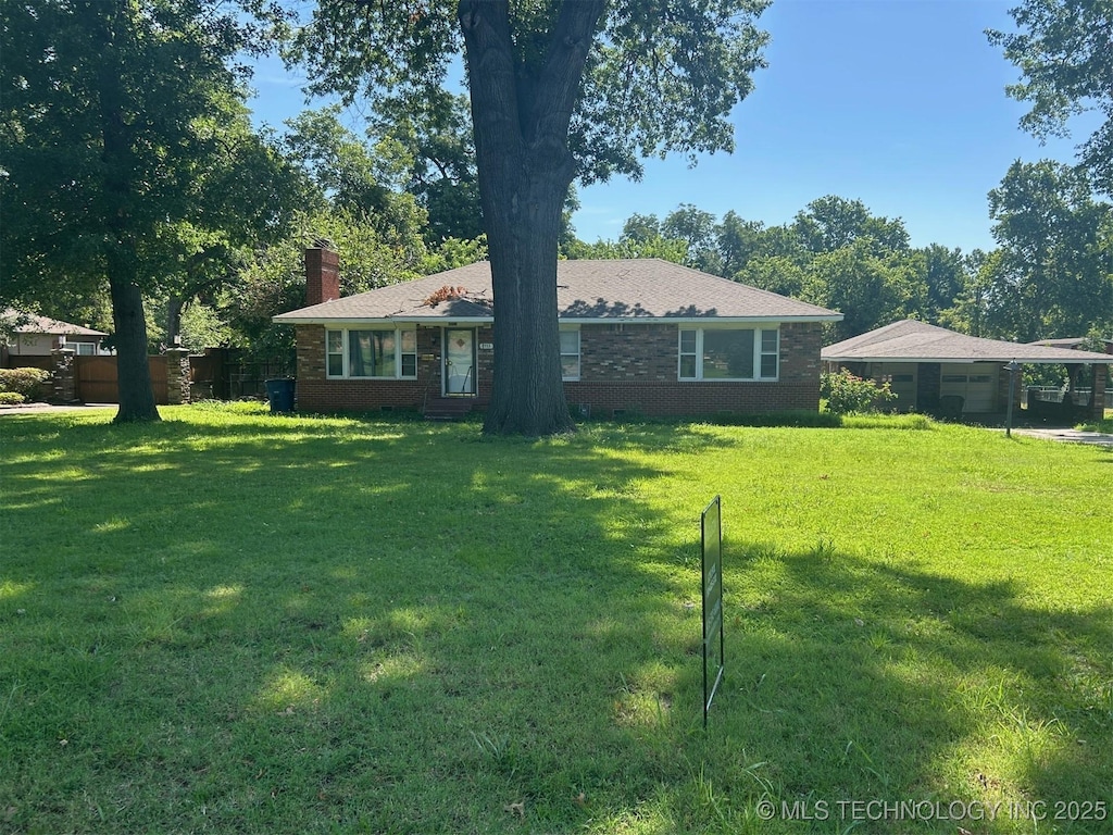 4553 S Jamestown Ave, Tulsa, OK 74135 - single story home featuring a chimney, a front lawn, a carport, and brick siding