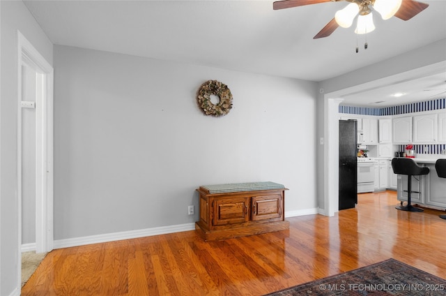 925 W Cedar St N, Durant, OK 74701 - living room with light wood-style flooring and ceiling fan