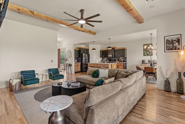 2407 W Union Pl, Collinsville, OK 74021 - living area featuring beam ceiling, ceiling fan, light wood-style floors, and a chandelier