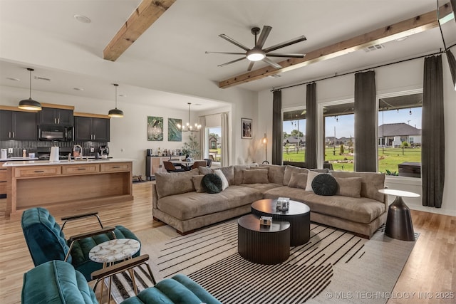 2407 W Union Pl, Collinsville, OK 74021 - living room featuring beamed ceiling, a chandelier, ceiling fan, and light wood-style flooring