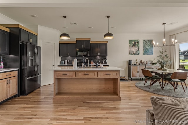 2407 W Union Pl, Collinsville, OK 74021 - kitchen featuring black appliances, light countertops, light wood-style floors, decorative backsplash, and a chandelier