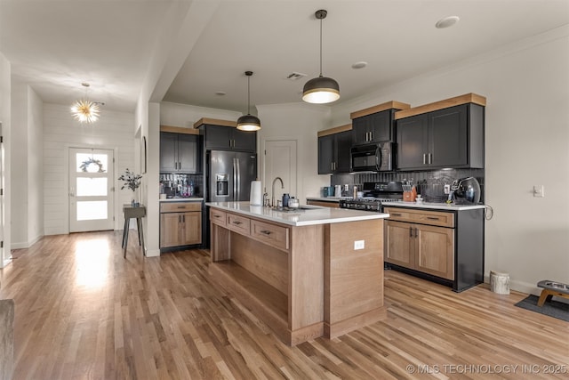 2407 W Union Pl, Collinsville, OK 74021 - kitchen with black appliances, decorative backsplash, light countertops, light wood-style flooring, and crown molding