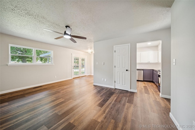 16524 E 2nd St, Tulsa, OK 74108 - unfurnished living room with a ceiling fan, dark wood-style floors, and a textured ceiling