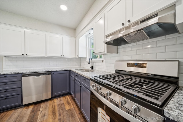16524 E 2nd St, Tulsa, OK 74108 - kitchen with appliances with stainless steel finishes, under cabinet range hood, gray cabinets, light stone counters, and recessed lighting