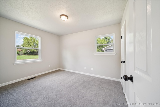 16524 E 2nd St, Tulsa, OK 74108 - carpeted spare room with baseboards and a textured ceiling