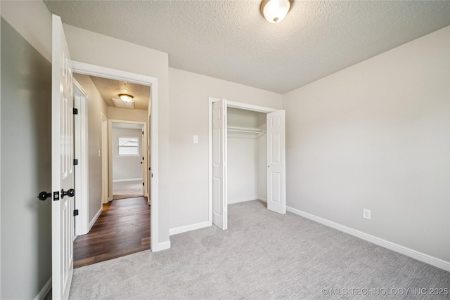16524 E 2nd St, Tulsa, OK 74108 - unfurnished bedroom with carpet floors, a textured ceiling, and a closet