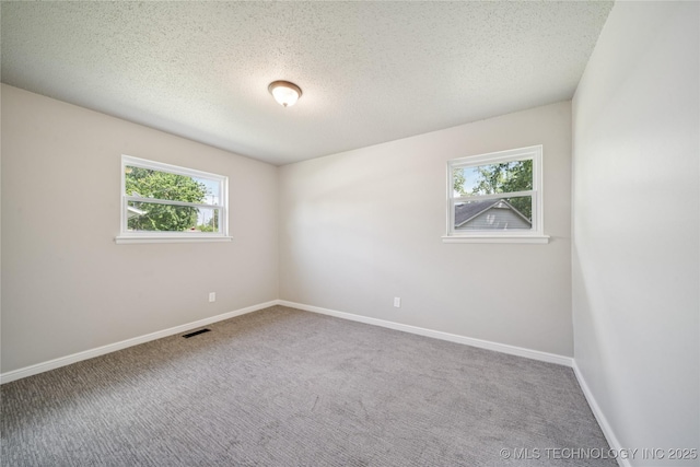 16524 E 2nd St, Tulsa, OK 74108 - carpeted empty room with healthy amount of natural light and a textured ceiling