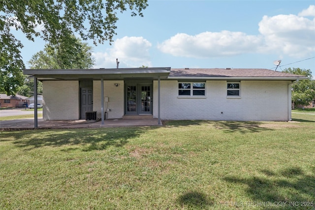 16524 E 2nd St, Tulsa, OK 74108 - rear view of property with french doors, a yard, and brick siding