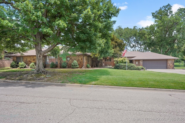 2425 E 53rd St, Tulsa, OK 74105 - view of front of property featuring stone siding, a garage, driveway, and a front lawn