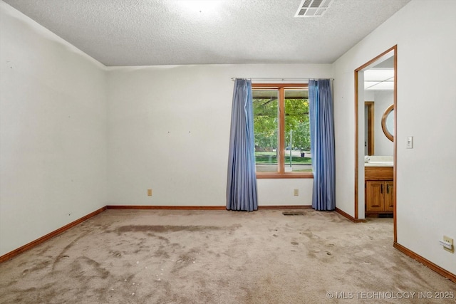 2425 E 53rd St, Tulsa, OK 74105 - unfurnished room featuring a textured ceiling and light colored carpet