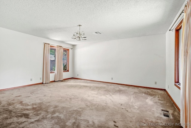 2425 E 53rd St, Tulsa, OK 74105 - carpeted spare room with a chandelier and a textured ceiling