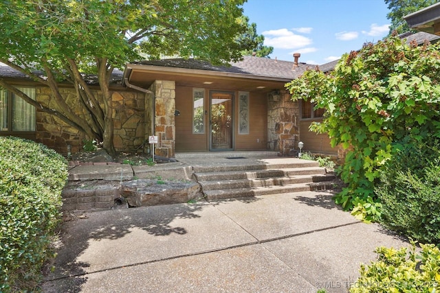 2425 E 53rd St, Tulsa, OK 74105 - entrance to property featuring stone siding and roof with shingles