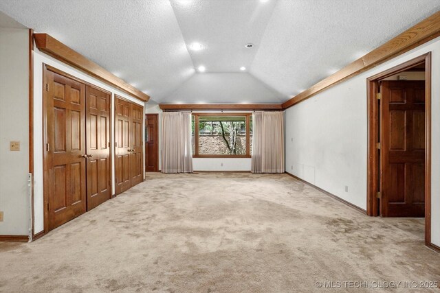 2425 E 53rd St, Tulsa, OK 74105 - unfurnished bedroom with vaulted ceiling, carpet flooring, recessed lighting, and a textured ceiling