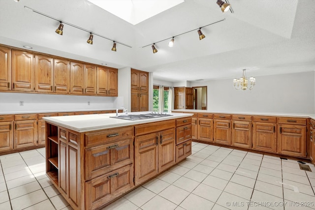 2425 E 53rd St, Tulsa, OK 74105 - kitchen with track lighting, gas cooktop, and brown cabinetry