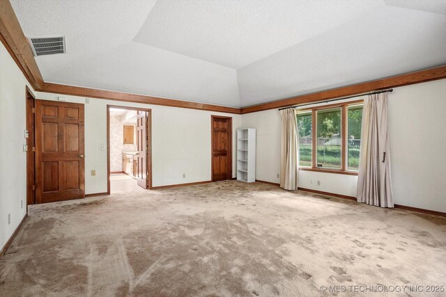 2425 E 53rd St, Tulsa, OK 74105 - unfurnished bedroom with carpet floors, vaulted ceiling, and ensuite bath