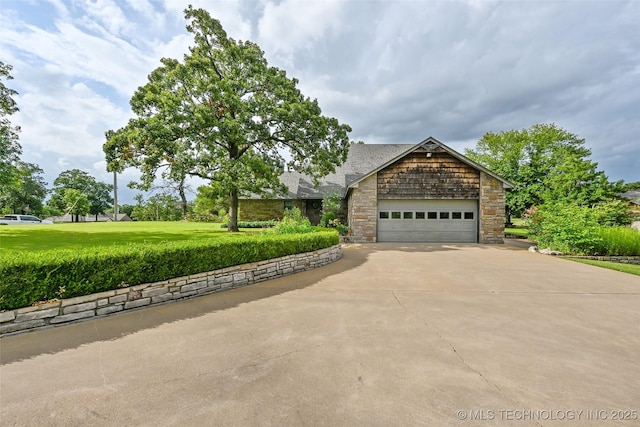 32069 Meadow Ln, Mannford, OK 74044 - view of front facade featuring driveway, stone siding, an attached garage, and a front lawn