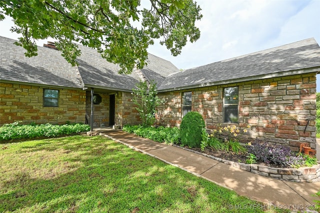 32069 Meadow Ln, Mannford, OK 74044 - view of front facade featuring stone siding and a front yard