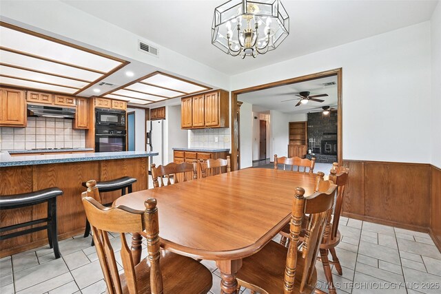 32069 Meadow Ln, Mannford, OK 74044 - dining room with light tile patterned flooring, recessed lighting, wainscoting, a ceiling fan, and a chandelier