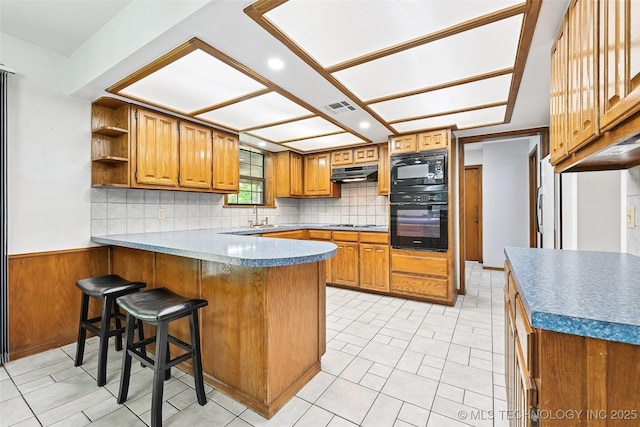 32069 Meadow Ln, Mannford, OK 74044 - kitchen with black appliances, a peninsula, brown cabinets, open shelves, and decorative backsplash