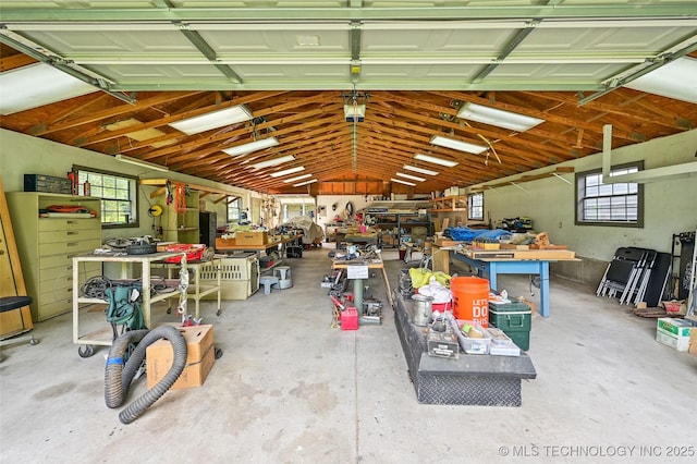 32069 Meadow Ln, Mannford, OK 74044 - garage featuring a workshop area and a garage door opener
