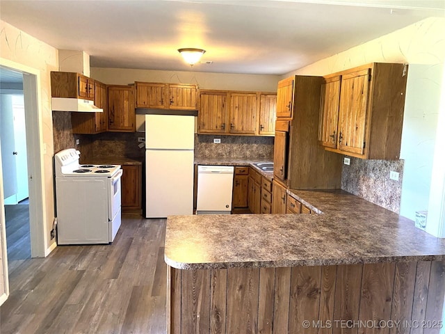 5940 E 3rd St, Tulsa, OK 74112 - kitchen with white appliances, under cabinet range hood, brown cabinetry, a peninsula, and backsplash