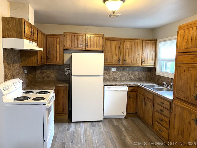 5940 E 3rd St, Tulsa, OK 74112 - kitchen with white appliances, under cabinet range hood, brown cabinets, and dark wood finished floors