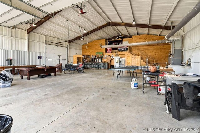 2724 Lark Rd, Kingston, OK 73439 - garage with a workshop area, metal wall, and a garage door opener