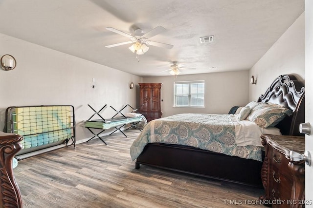 2724 Lark Rd, Kingston, OK 73439 - bedroom with wood finished floors and a ceiling fan