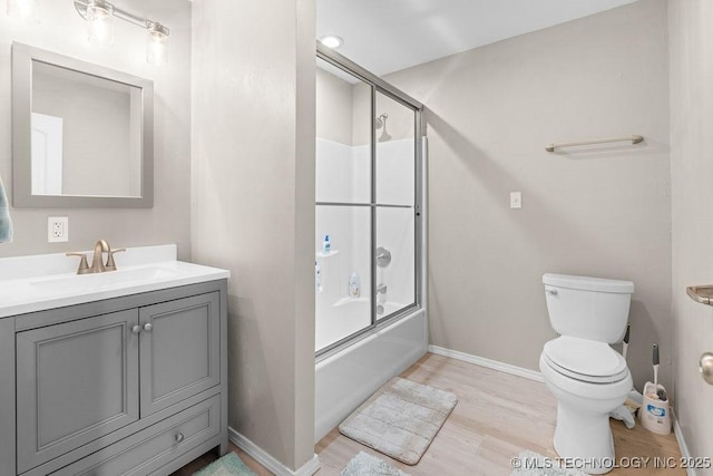 2724 Lark Rd, Kingston, OK 73439 - full bathroom featuring vanity, wood finished floors, and bath / shower combo with glass door