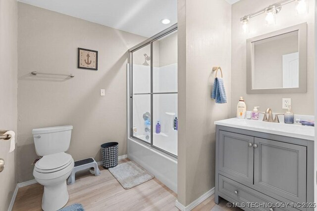 2724 Lark Rd, Kingston, OK 73439 - full bathroom with wood finished floors, vanity, and shower / bath combination with glass door