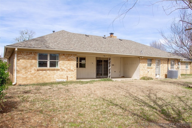 6740 E 51st Pl, Tulsa, OK 74145 - back of house featuring a chimney, brick siding, a shingled roof, and a yard