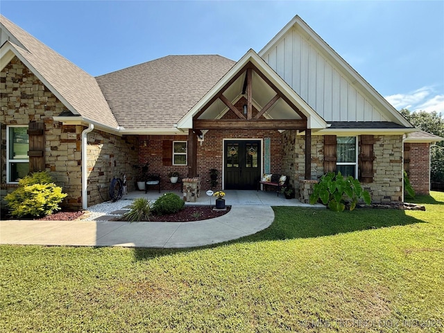 18040 County Road 1558, Ada, OK 74820 - view of front of house featuring board and batten siding, a front lawn, stone siding, and roof with shingles