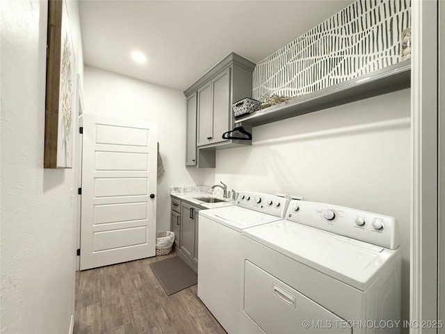 18040 County Road 1558, Ada, OK 74820 - laundry room with washer and clothes dryer, wood finished floors, and cabinet space