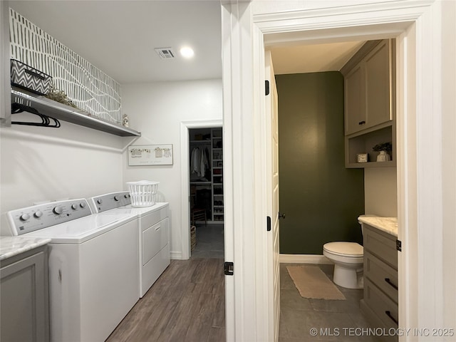 18040 County Road 1558, Ada, OK 74820 - washroom with washer and dryer and dark wood-style floors