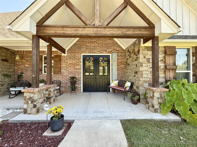 18040 County Road 1558, Ada, OK 74820 - entrance to property with board and batten siding, brick siding, french doors, and a shingled roof