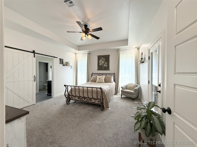 18040 County Road 1558, Ada, OK 74820 - carpeted bedroom with a barn door, connected bathroom, and a ceiling fan