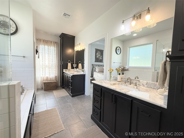 18040 County Road 1558, Ada, OK 74820 - full bathroom with healthy amount of natural light, two vanities, tiled bath, and tile patterned floors