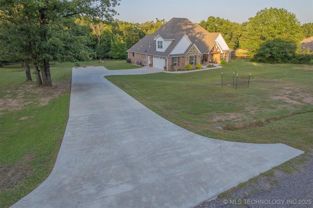 18040 County Road 1558, Ada, OK 74820 - view of front of house with stone siding, driveway, a front lawn, and a garage